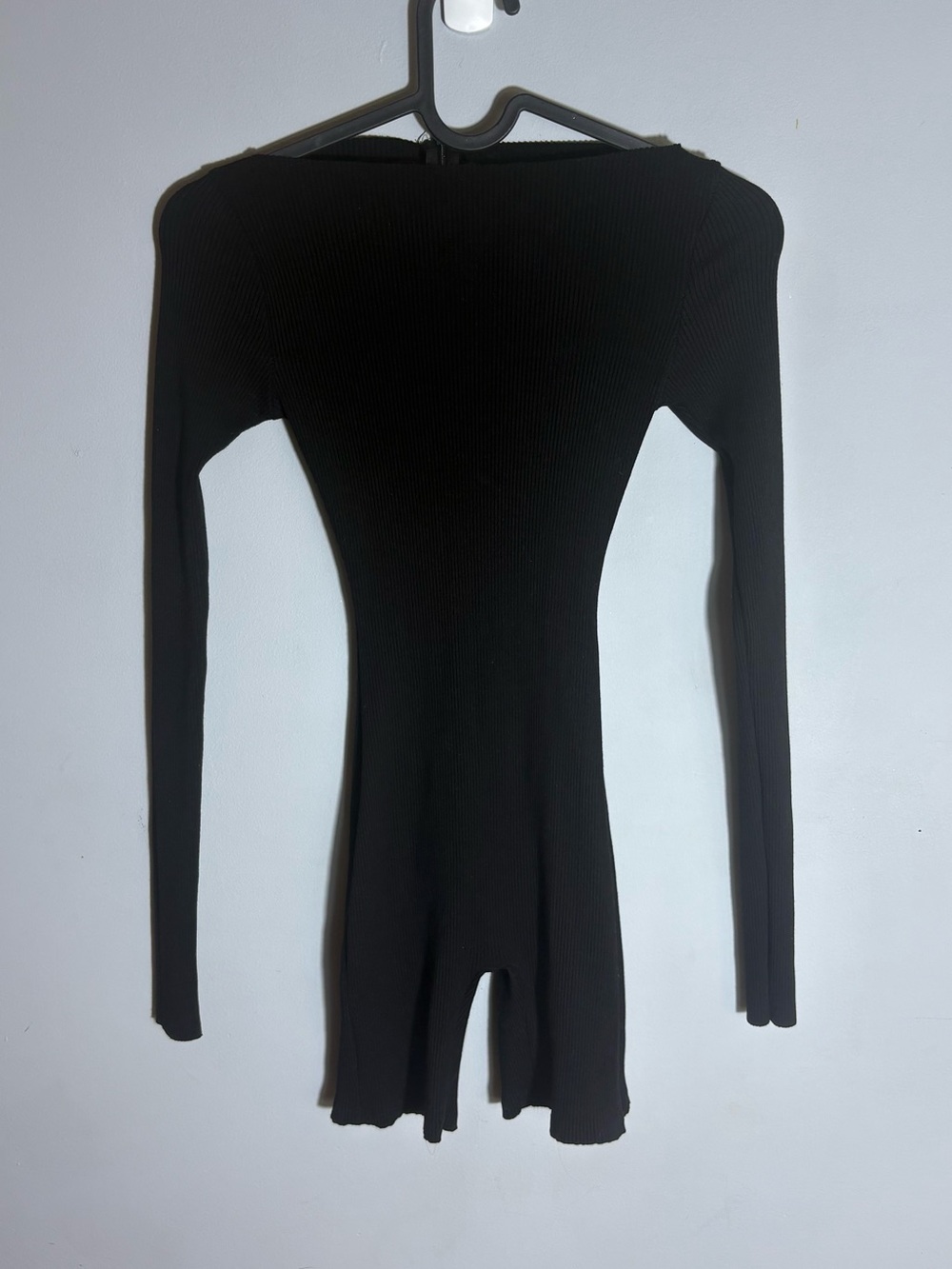 Naked Culture signature sculpted raw-cut long sleeve black jumpsuit.